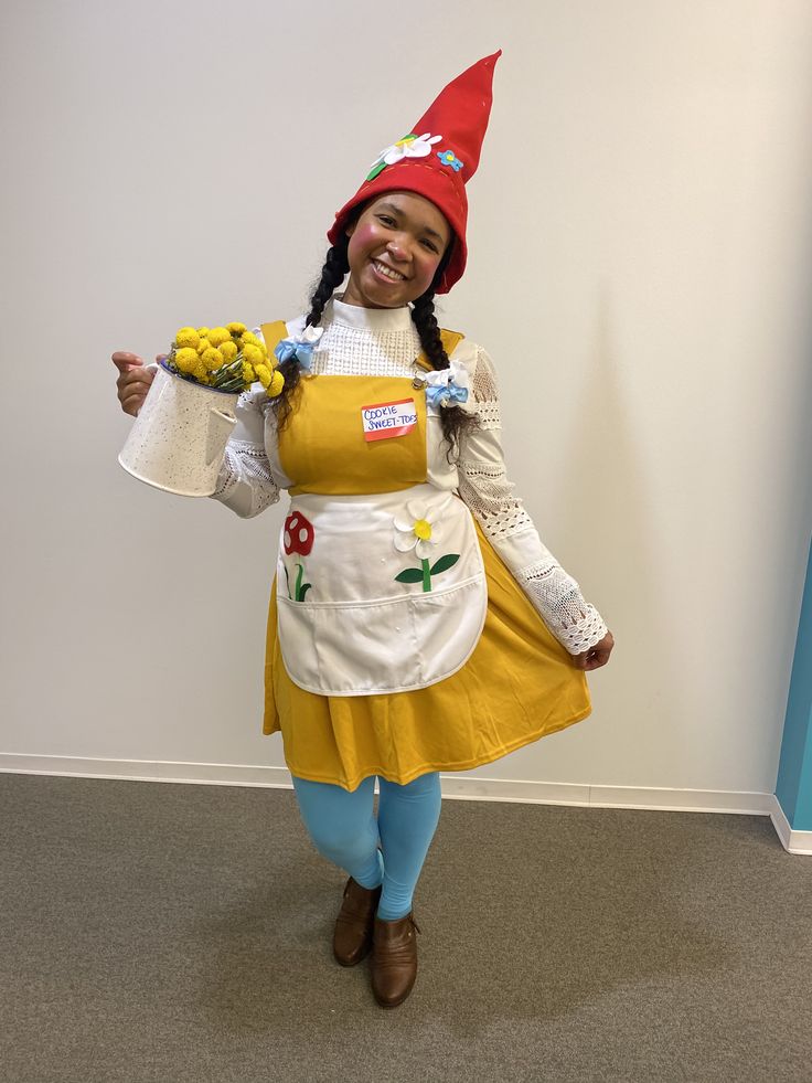 a woman dressed as a little red riding on the back of a yellow dress and holding flowers