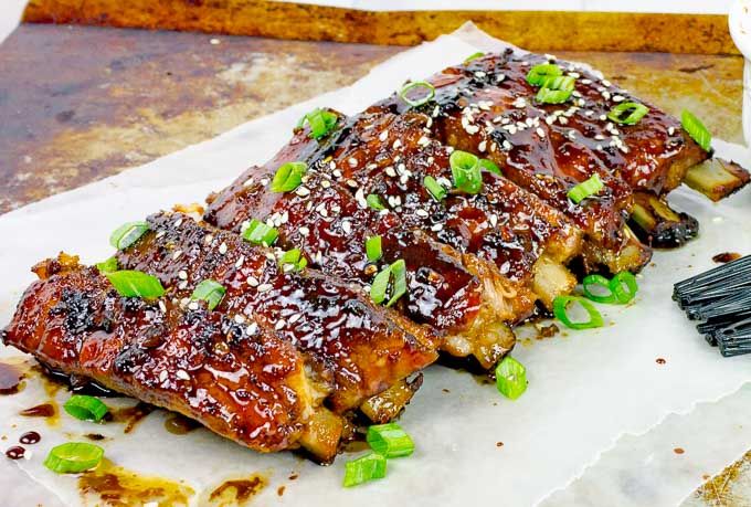 the ribs are covered in sauce and green onions