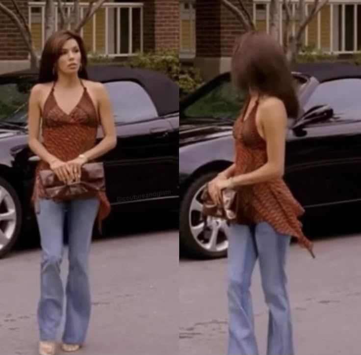 two women walking down the street, one carrying a purse and the other wearing flarey jeans