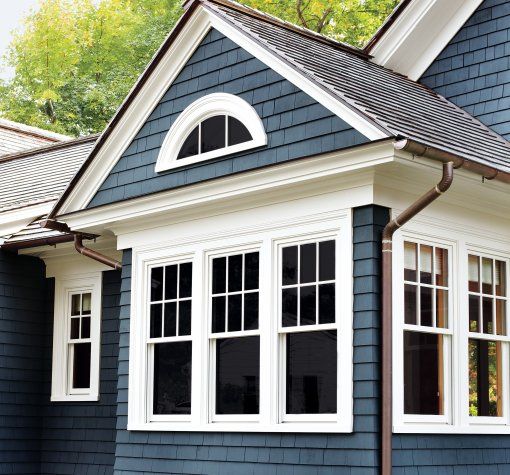 a blue house with white trim and windows