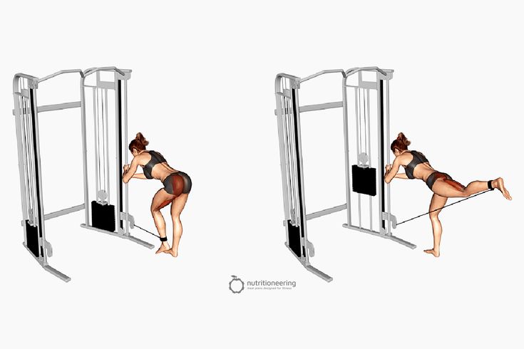 a woman is doing squats on a pull up machine