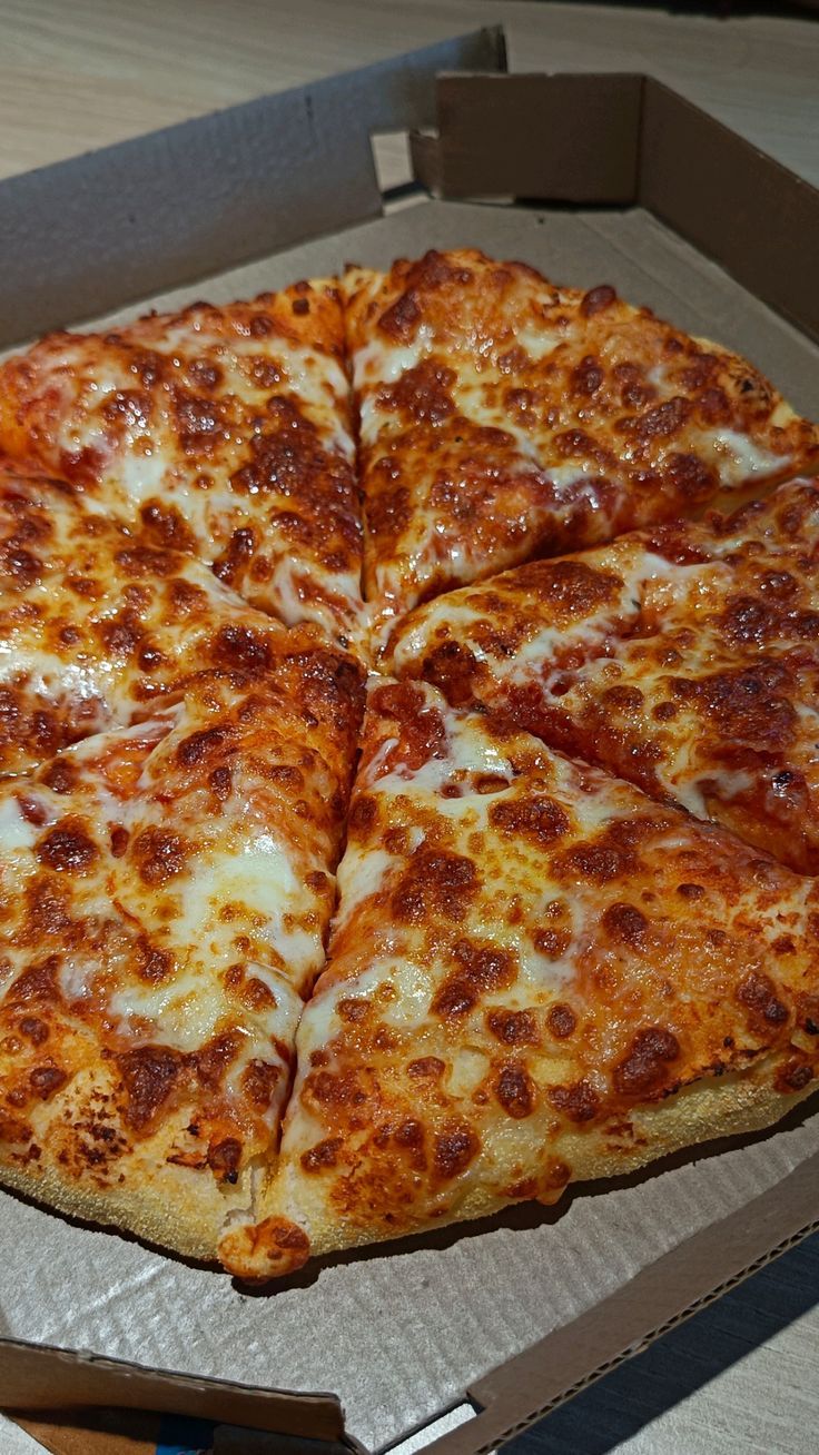 a pizza sitting in a box on top of a table