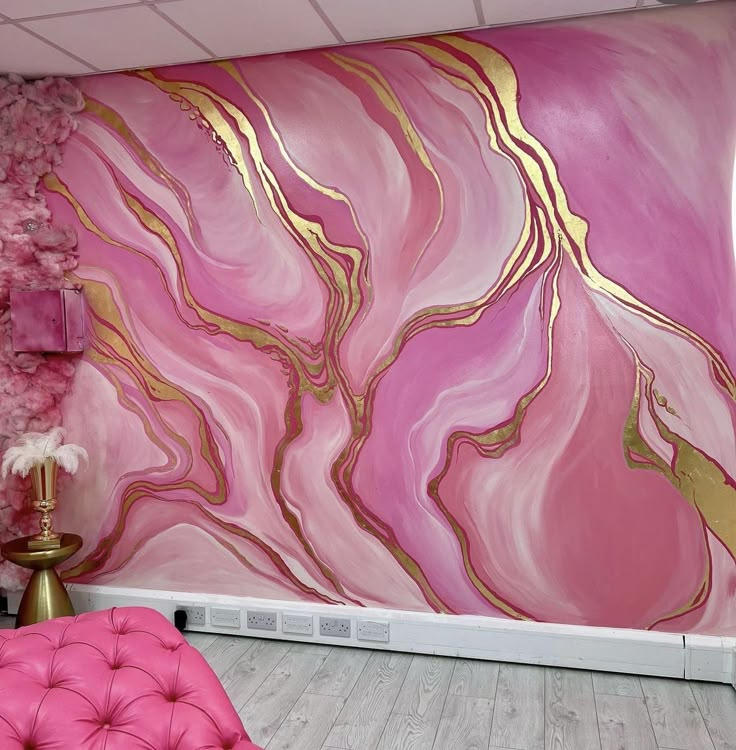 a pink and gold painted wall in a living room