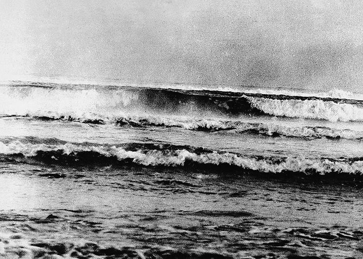 a black and white photo of the ocean waves