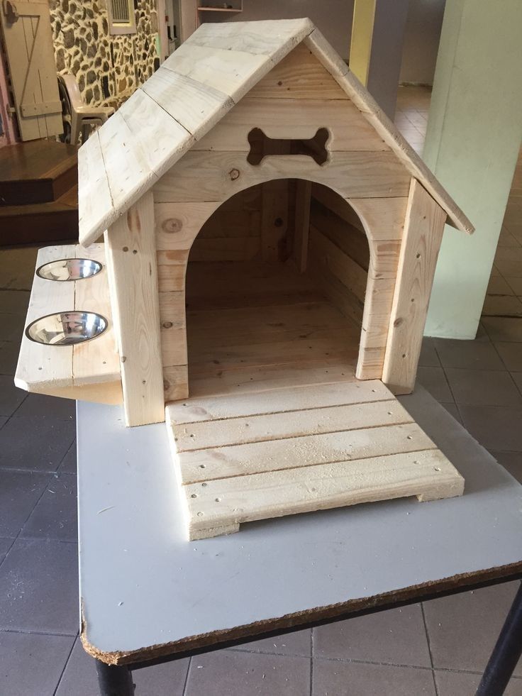 a wooden dog house with a bone on the top