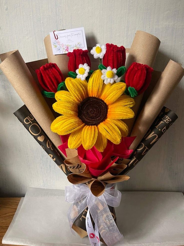 a bouquet of flowers is wrapped in brown paper