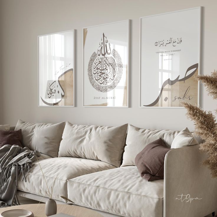 a living room filled with white furniture and pictures on the wall above it's couch