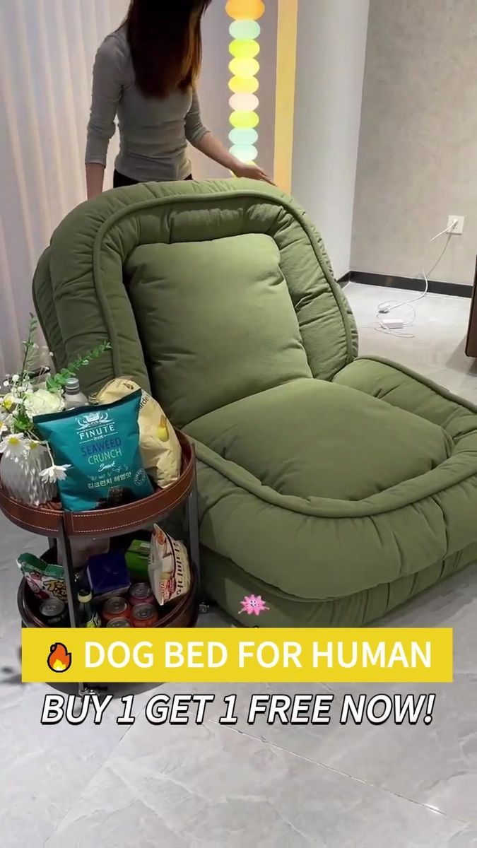 a woman standing next to a dog bed for human