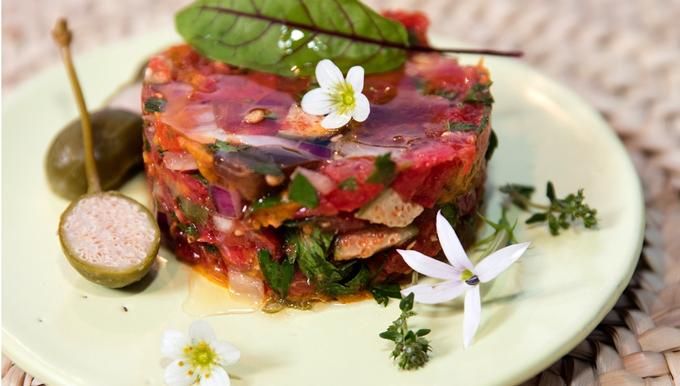 a piece of food on a plate with some flowers