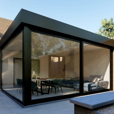 a house with glass walls and patio furniture