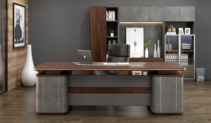 an office with wood flooring and gray walls, along with a large wooden desk