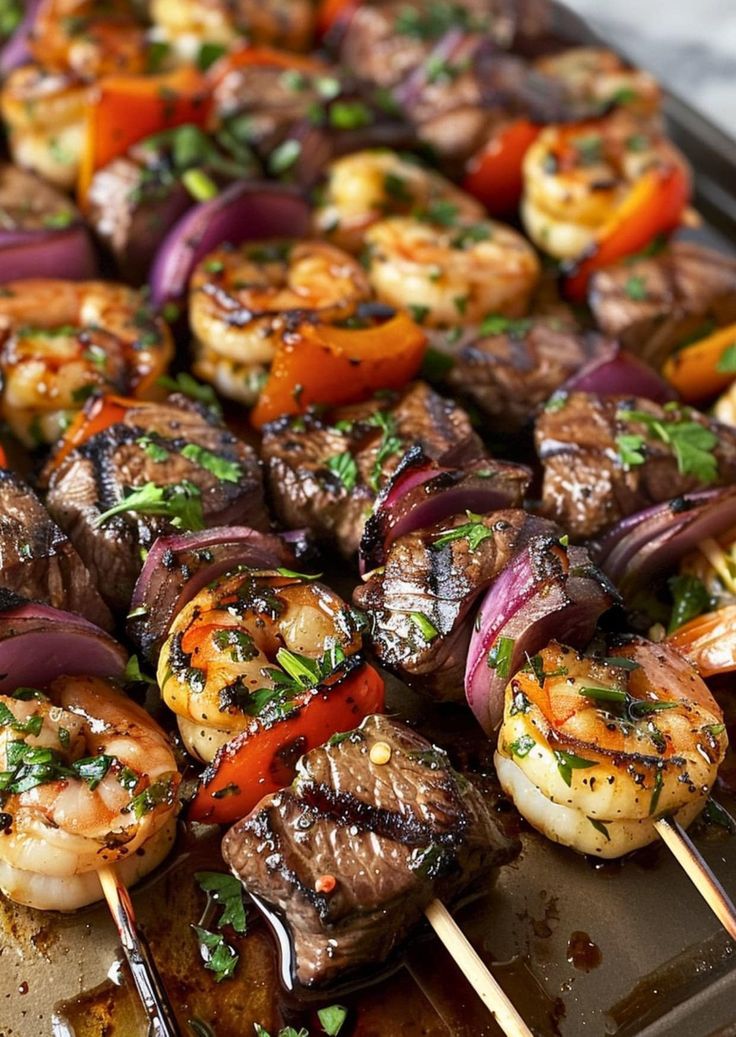 skewers of meat and vegetables on a grill