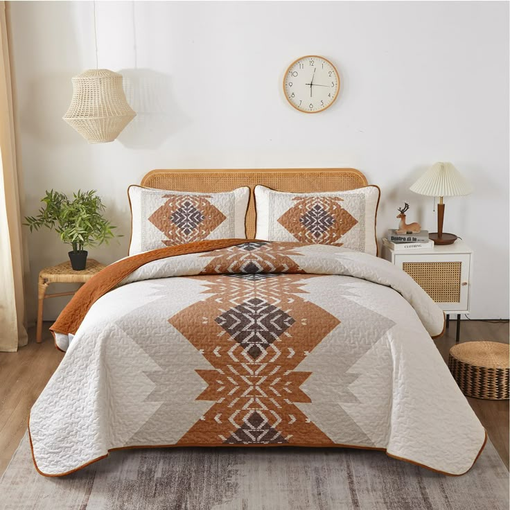 a bed with an orange and white bedspread in a bedroom next to a clock