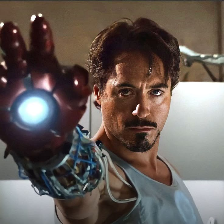 the iron man is holding his hand up in front of him with an eyeball on it