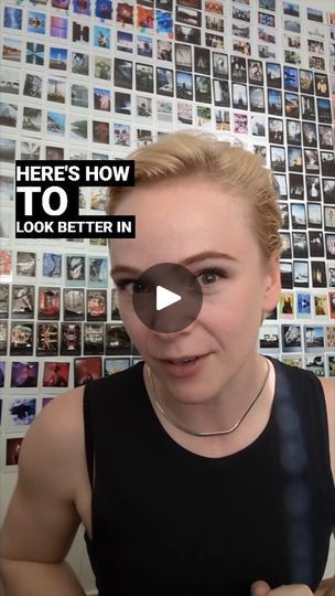 a woman with short blonde hair wearing a black tank top and looking at the camera