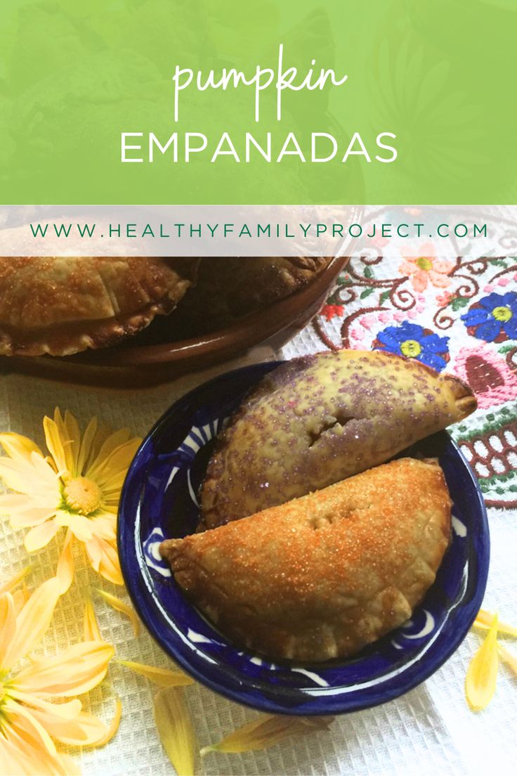 pumpkin empanadas on a blue plate with yellow flowers in the background and text overlay