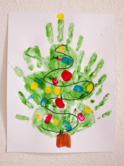 a child's handprint christmas tree is shown