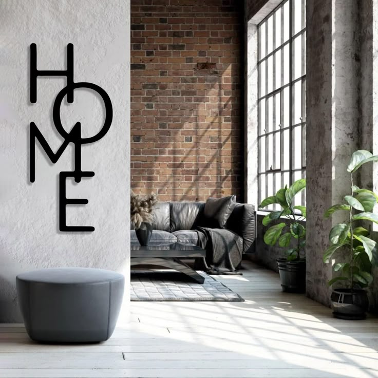 a modern living room with brick walls and large metal letters that spell out the word home