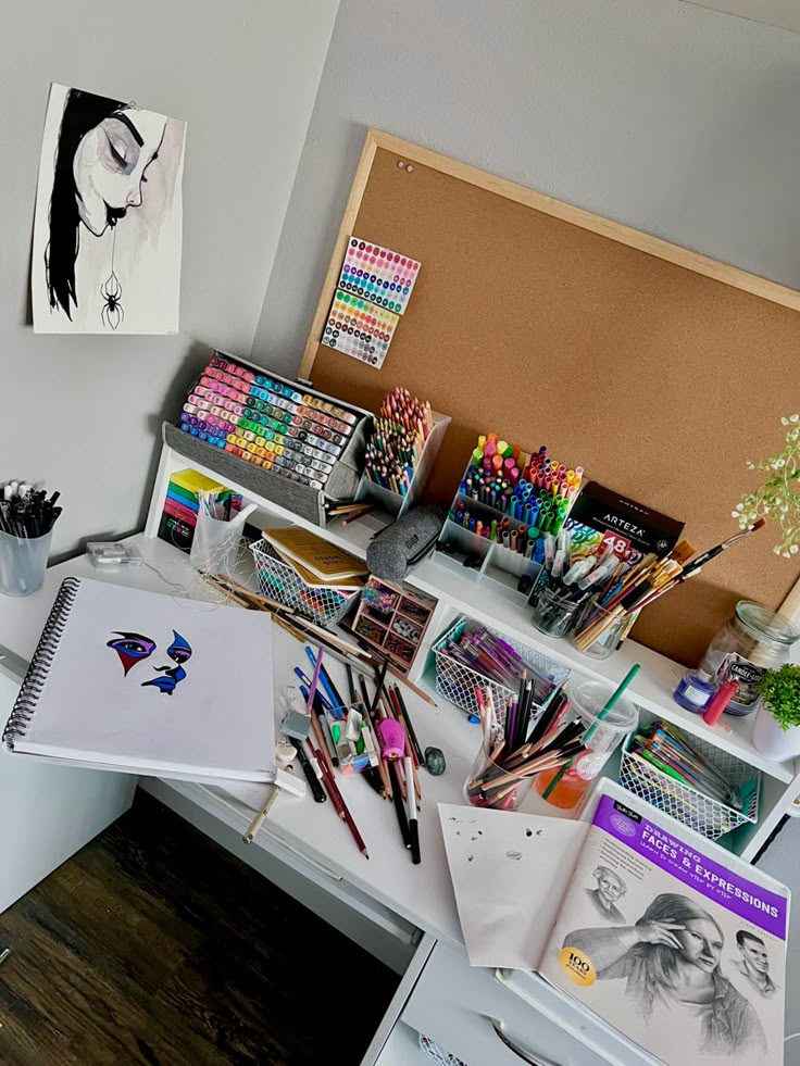 the desk is full of pens, markers and other art supplies on it's shelves