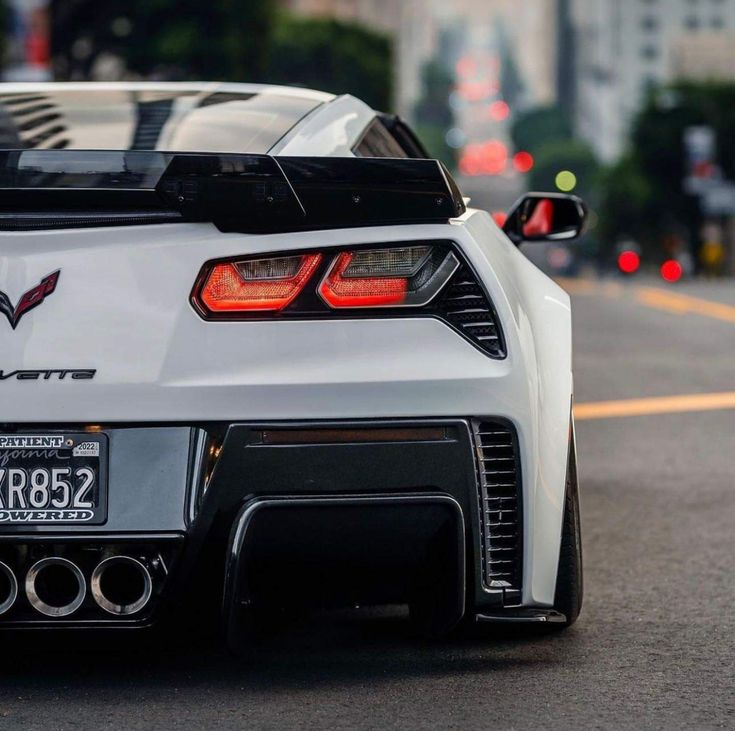 the back end of a white sports car