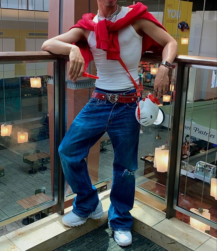 a man standing on a balcony with his hand on his hip and wearing a bandana