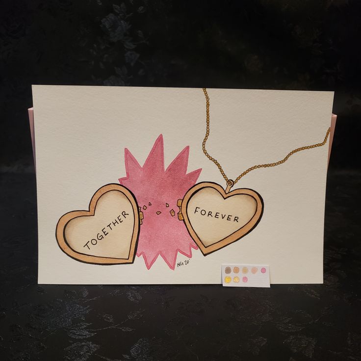 two hearts with words together on them hanging from a string attached to a card that says together forever