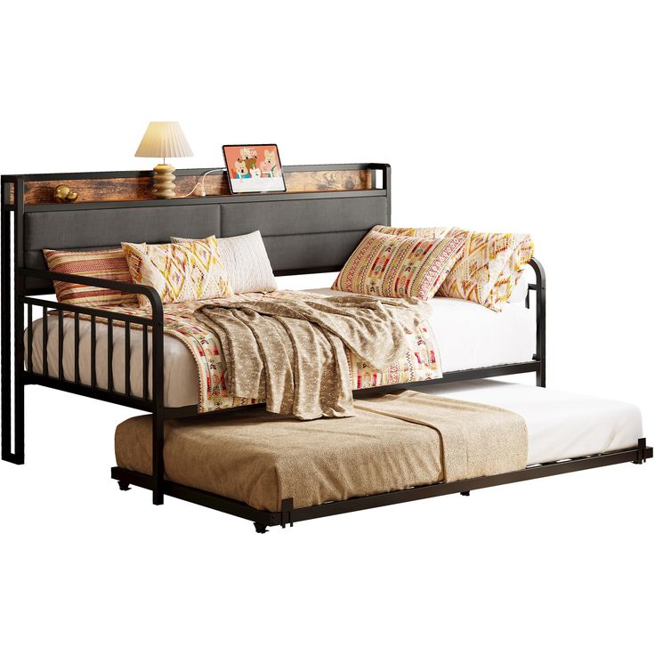 a day bed with a pull out trundle and pillows on it's sides