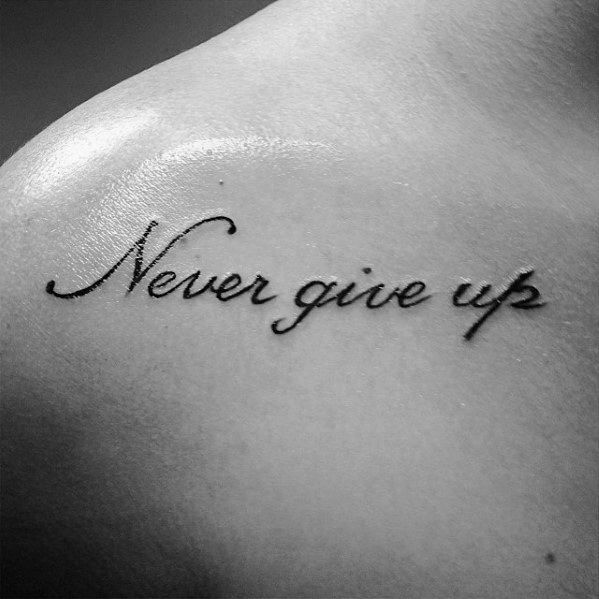 a man's chest with the words never give up on it