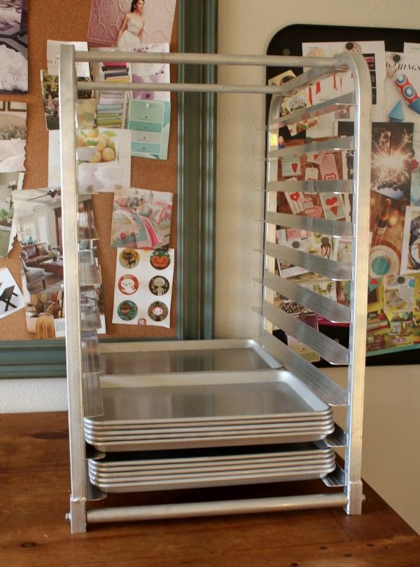 a stack of metal trays sitting on top of a wooden table