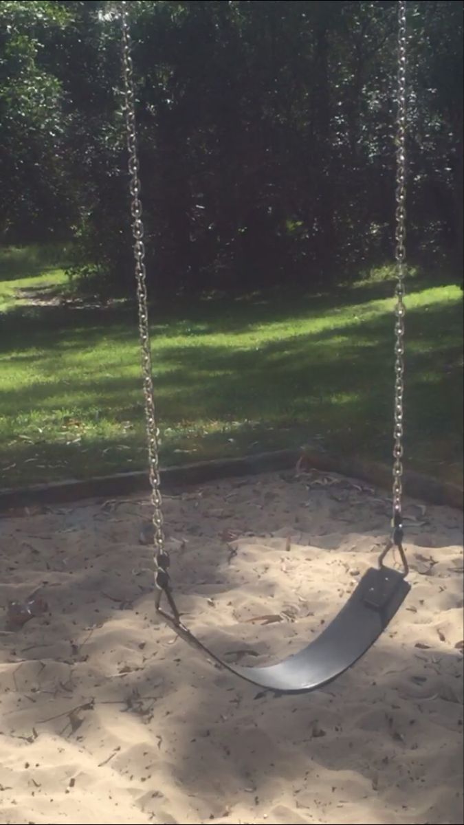 a swing in the sand at a park