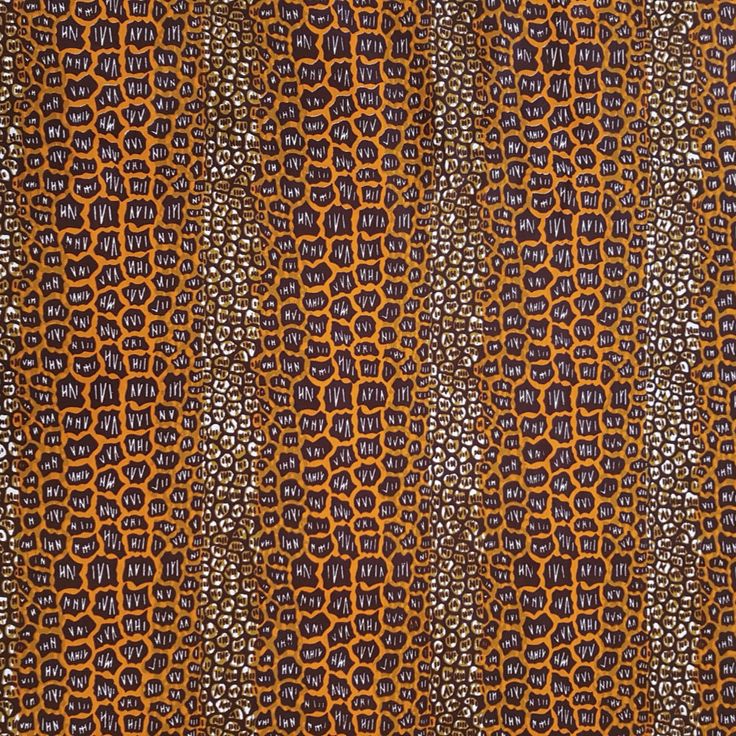 an orange and black pattern on fabric that looks like it is made out of cloth