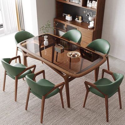 a dining room table with green chairs around it