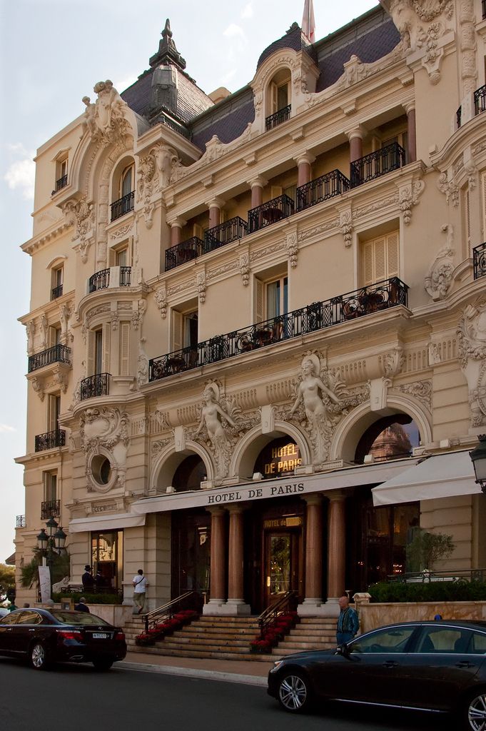 cars are parked in front of an ornately decorated building with balconies and balconyes