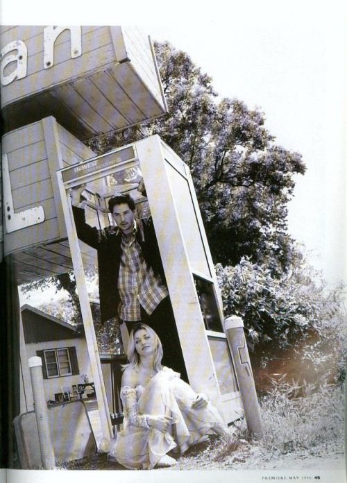 a man and woman standing in front of a building