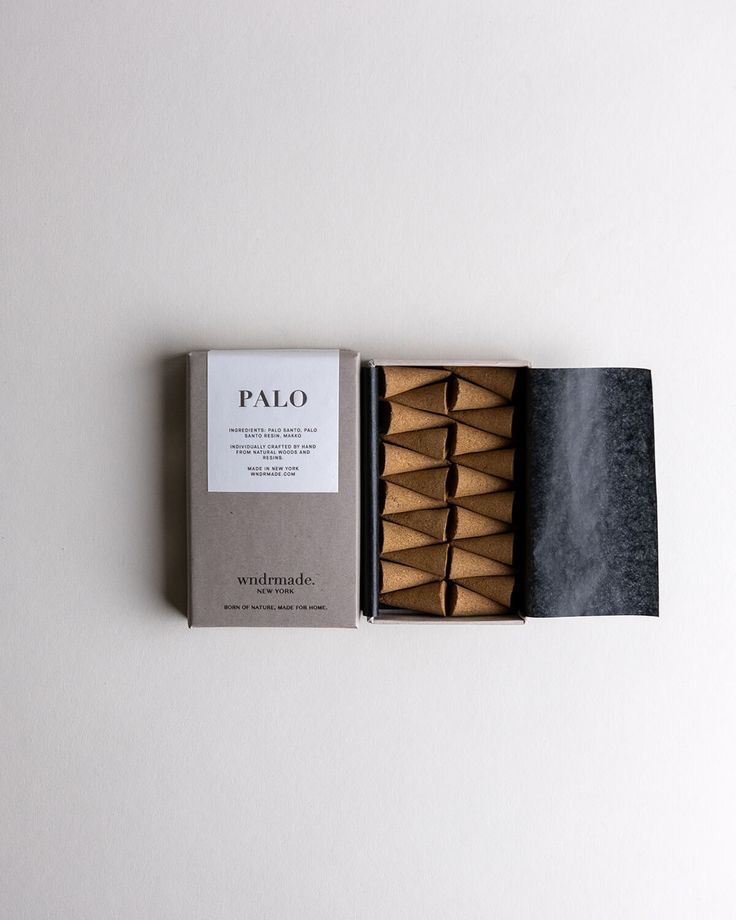 an open box of palo incense sticks on a white surface with the package in it