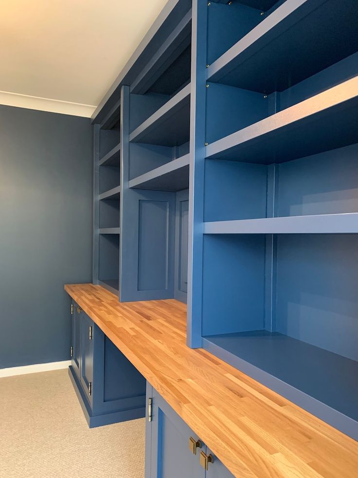 a room with blue shelves and wood counter tops