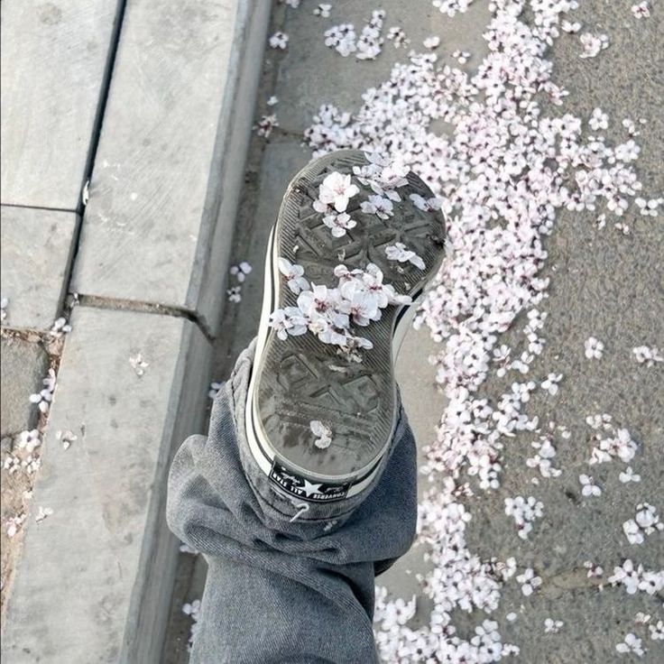 someone standing on the sidewalk with their feet covered in confetti