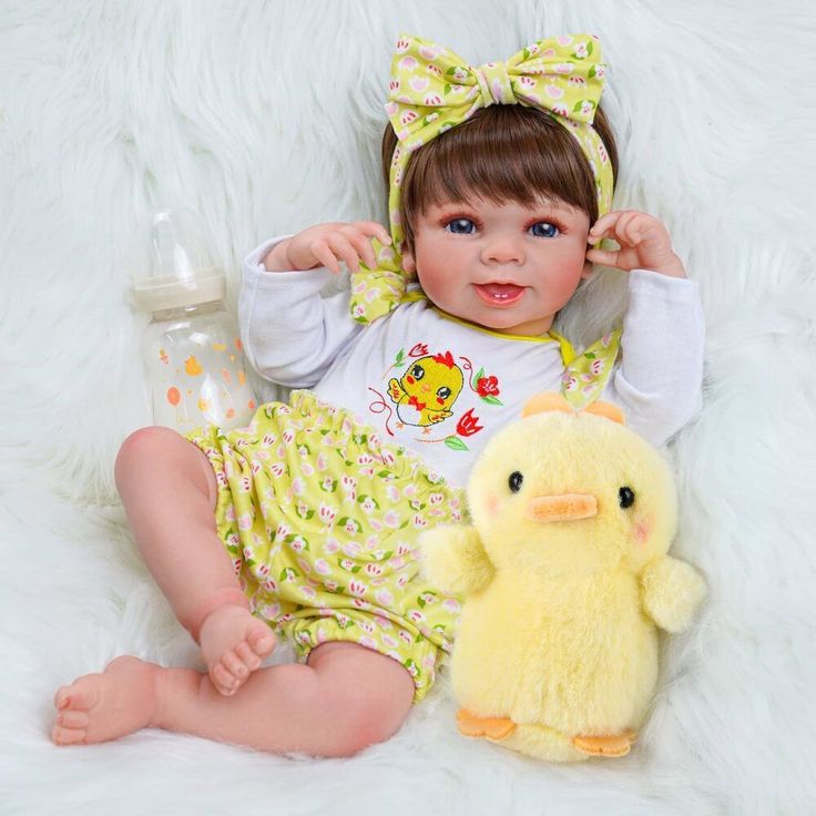 a baby girl with a yellow ducky doll