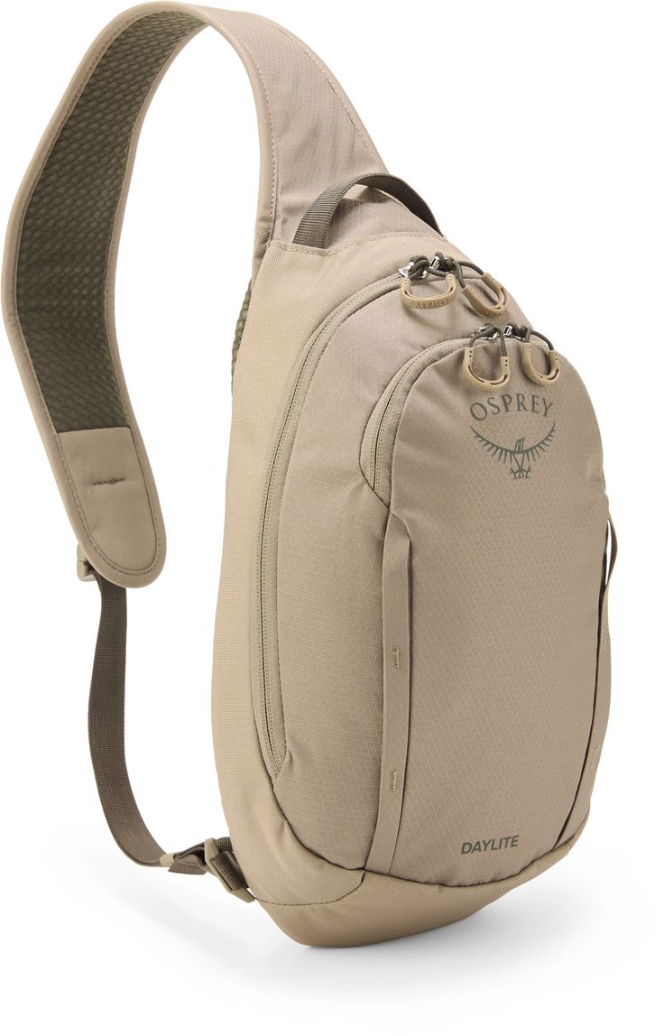 a beige sling backpack with an adjustable strap