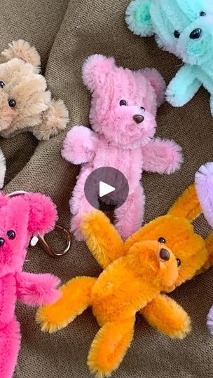 a group of stuffed teddy bears sitting on top of a brown couch next to each other