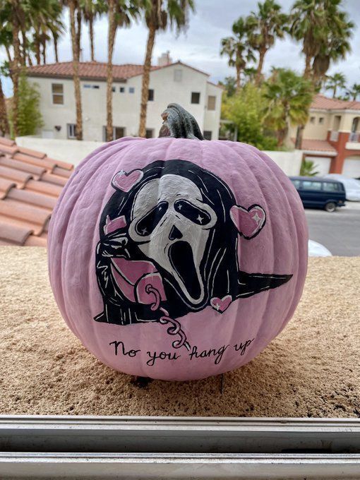 a pink pumpkin with an image of a dog on it