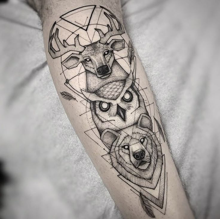 a man's arm with an animal and geometric tattoo design on the left forearm