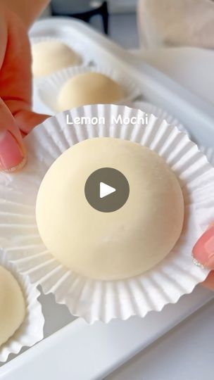 a person is placing some food on top of paper plates with their thumbnails