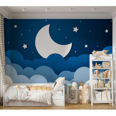 a child's bedroom decorated in blue and white with stars on the moon mural