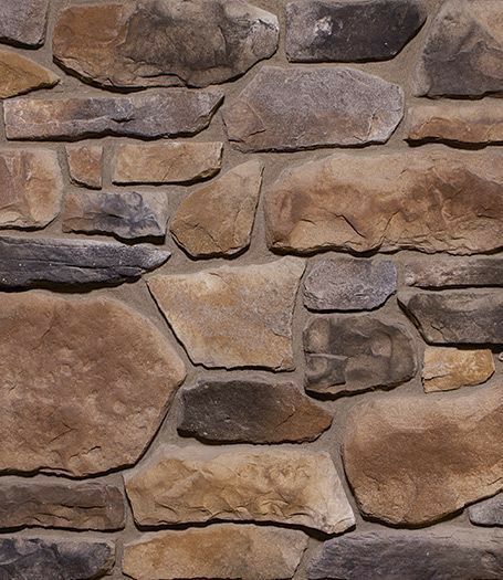 a stone wall that is made out of various types of rocks