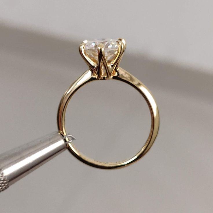 a close up of a ring with a diamond on it