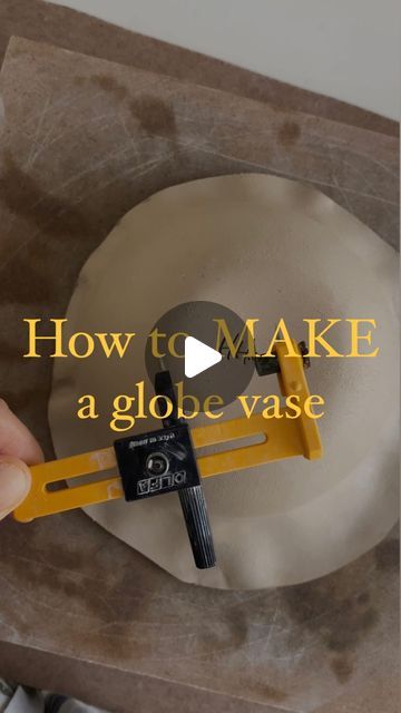 a person holding a piece of paper with the words how to make a globe vase