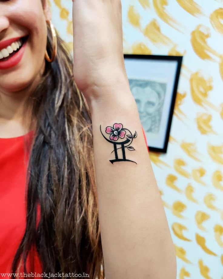 a woman with a flower tattoo on her arm