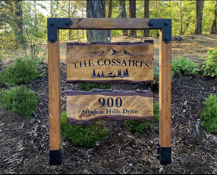 a sign for the coosair's wilderness preserve in front of some trees