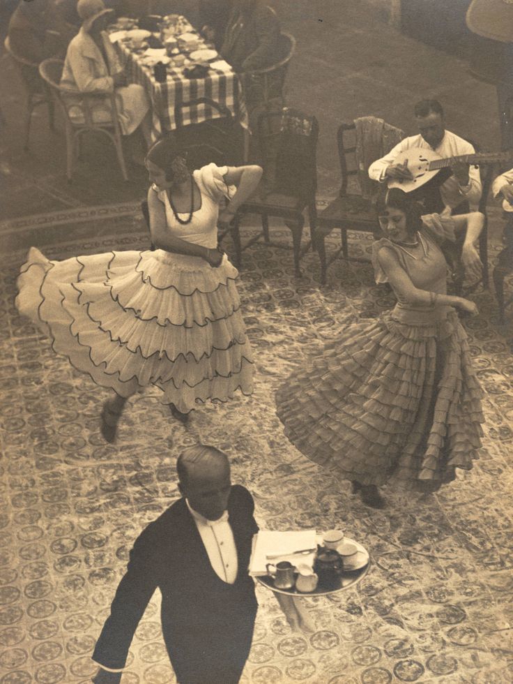 an old photo of some people dancing